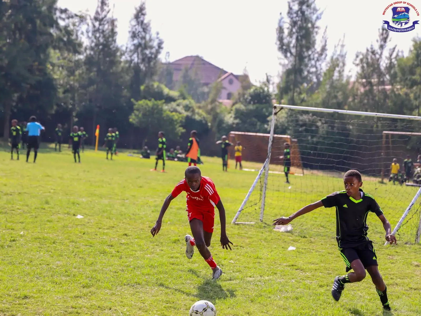 Whitestar pupils playing football on the school field