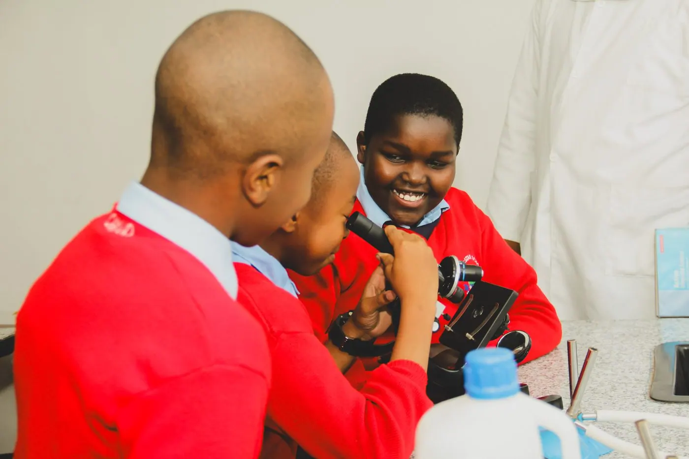 Whitestar pupils working together at a microscope